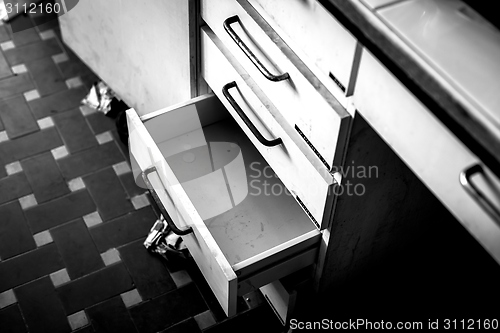 Image of Cupboard with opened empty drawer