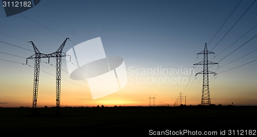 Image of Large transmission towers at sunset