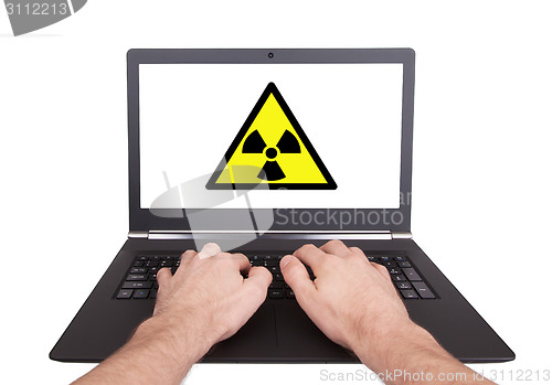 Image of Man working on laptop, radiation