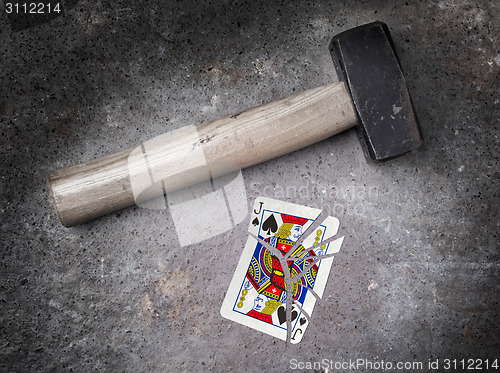 Image of Hammer with a broken card, jack of spades