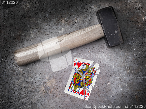 Image of Hammer with a broken card, jack of hearts