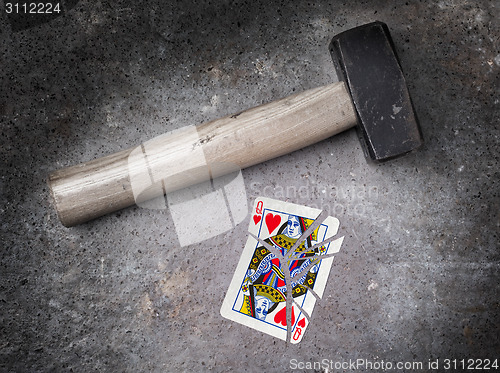 Image of Hammer with a broken card, queen of hearts