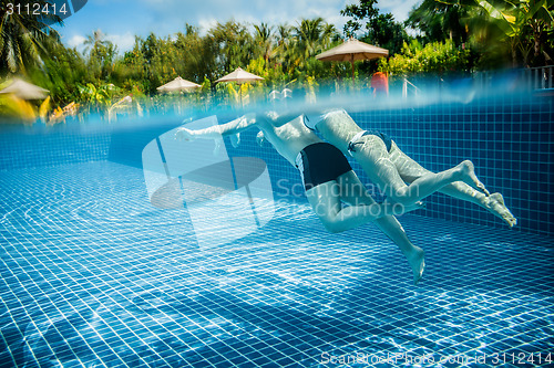 Image of Couple floating in the pool on holiday