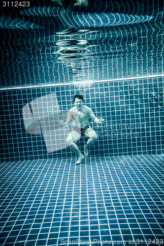 Image of Persons standing under water in a swimming pool