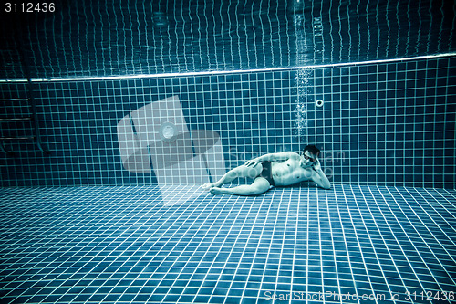 Image of Persons lies under water in a swimming pool