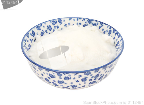 Image of White caster sugar in a blue and white china bowl