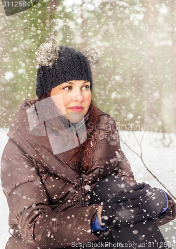 Image of Portrait of the charming young woman in winter outdoors 