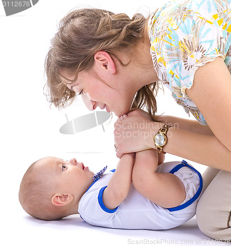 Image of baby boy lying on white floor