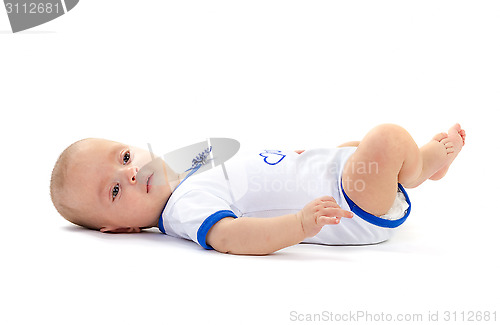 Image of baby boy lying on white floor