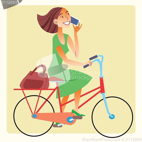 Image of Young woman riding a bike and talking on the smartphone