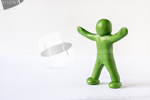 Image of Green man with his hands up