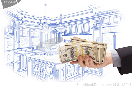 Image of Hand Holding Cash Over Custom Kitchen Design Drawing