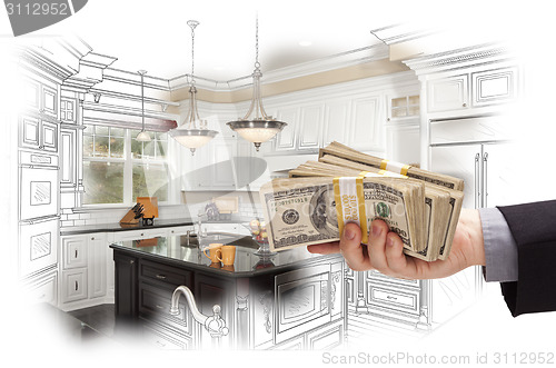 Image of Hand Holding Cash Over Kitchen Design Drawing and Photo Combinat