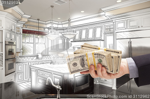 Image of Hand Holding Cash Over Kitchen Design Drawing and Photo Combinat