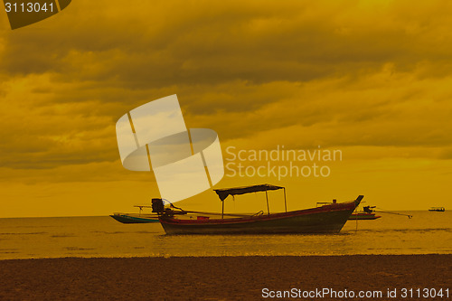 Image of boat on the beach and sunset 