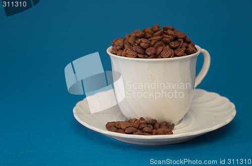 Image of Coffee cup full of coffee beans