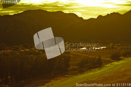 Image of  fishing villages near mountain and sunset