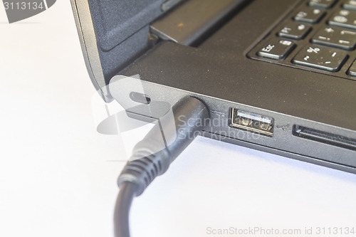 Image of computer with power plug