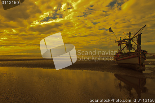 Image of boat on the beach and sunset 