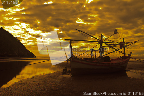 Image of boat on the beach and sunset 