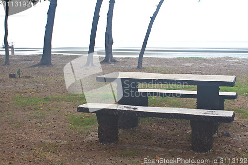 Image of stone  bench with sea background