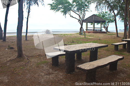 Image of stone  bench with sea background