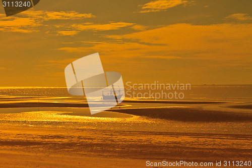 Image of boat on the beach and sunset 