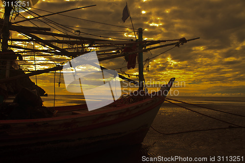 Image of boat on the beach and sunset 