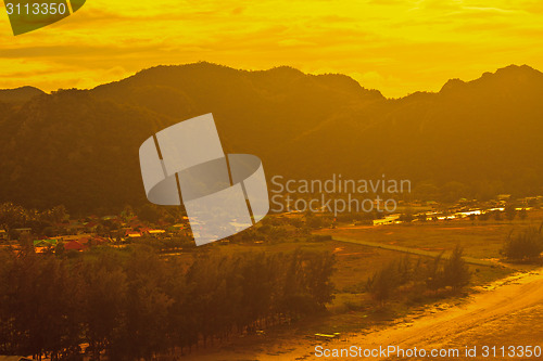 Image of  fishing villages near mountain and sunset