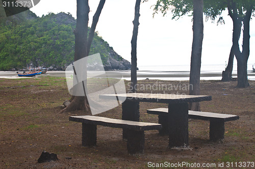 Image of stone  bench with sea background