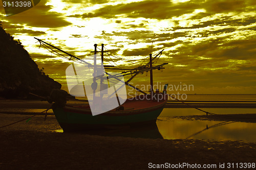 Image of boat on the beach and sunset 