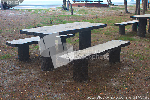 Image of stone  bench with sea background