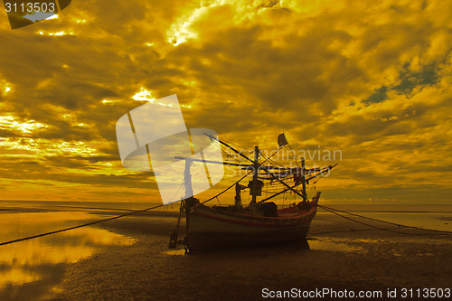 Image of boat on the beach and sunset 