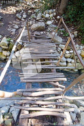 Image of city ruins Olimpos bridge through a stream