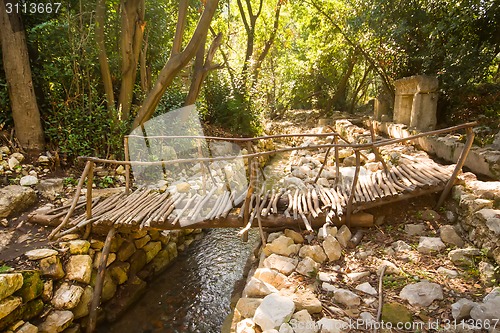 Image of city ruins Olimpos bridge through a stream