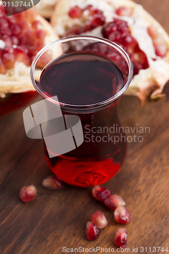 Image of Ripe pomegranates with juice on table