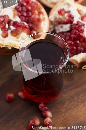 Image of Ripe pomegranates with juice on table