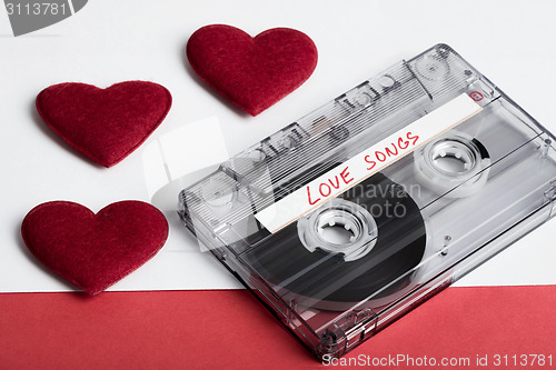 Image of Audio cassette tape on red backgound with fabric heart