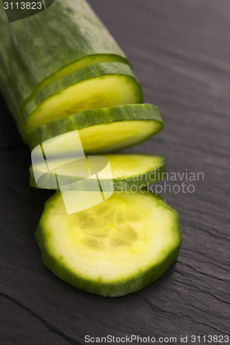 Image of cucumber slices on on black plate