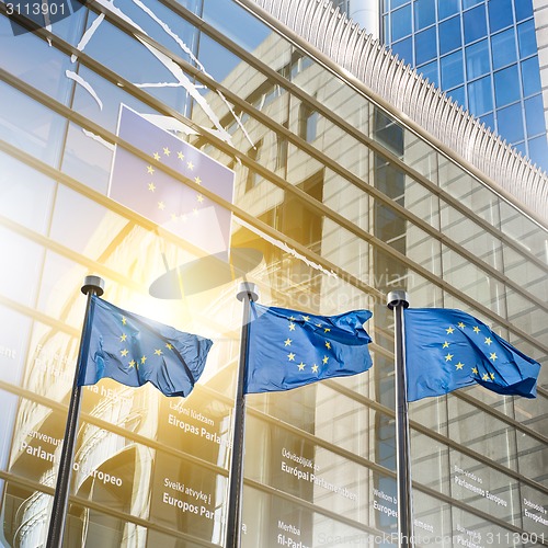 Image of European union flag against parliament in Brussels