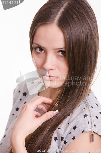 Image of Portrait of serious girl touch the hair