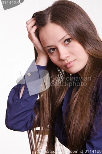 Image of Girl with long hair rests his head on  hand