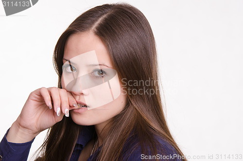 Image of Beautiful girl raised hand to her mouth