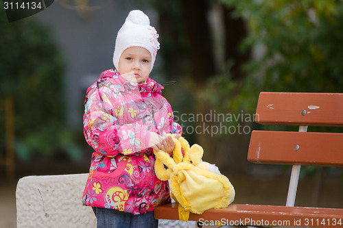 Image of Upset girl in autumn clothes shops costs about