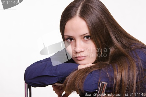 Image of Portrait of a pretty girl leaning back in his chair