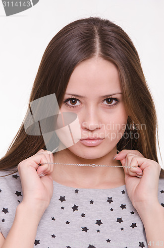 Image of Beautiful girl holds a chain around his neck