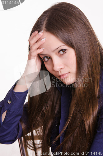 Image of Girl with long hair holds a hand to his forehead