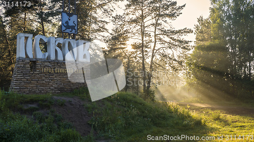 Image of Sunset light in forest near Pskov city sign 