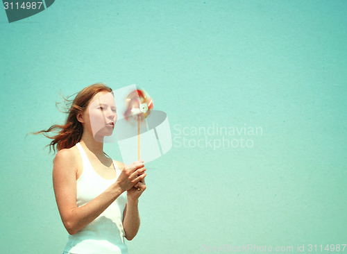 Image of Young woman with a colorful pinwheel