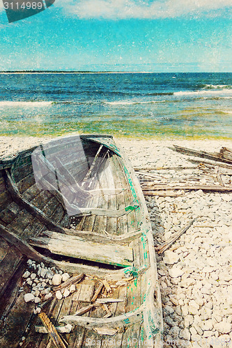 Image of Old wooden boat on the seashore, retro image